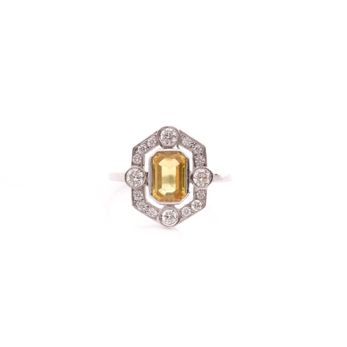 125 - A platinum, diamond, and sapphire dress ring, set with an emerald-cut yellow sapphire of approximate... 
