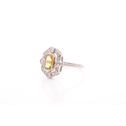 125 - A platinum, diamond, and sapphire dress ring, set with an emerald-cut yellow sapphire of approximate... 