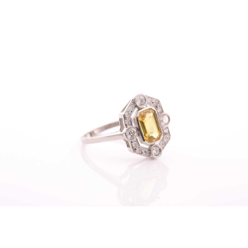 125 - A platinum, diamond, and sapphire dress ring, set with an emerald-cut yellow sapphire of approximate... 