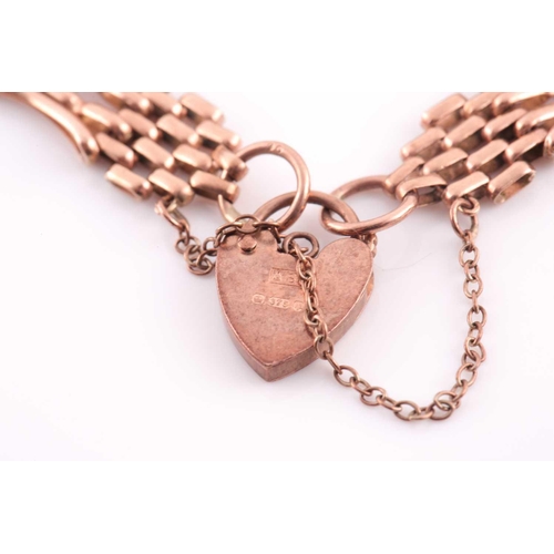 137 - A 9 carat rose gold gate link bracelet; with shaped, waisted links and padlock clasp; 10.6 grams.