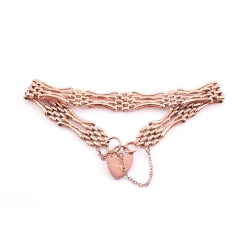 137 - A 9 carat rose gold gate link bracelet; with shaped, waisted links and padlock clasp; 10.6 grams.