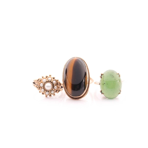 144 - A single stone jade ring; the oval stone in claw mounts to plain 9 carat gold shank; a split pearl c... 