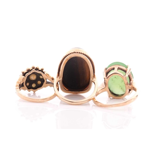 144 - A single stone jade ring; the oval stone in claw mounts to plain 9 carat gold shank; a split pearl c... 