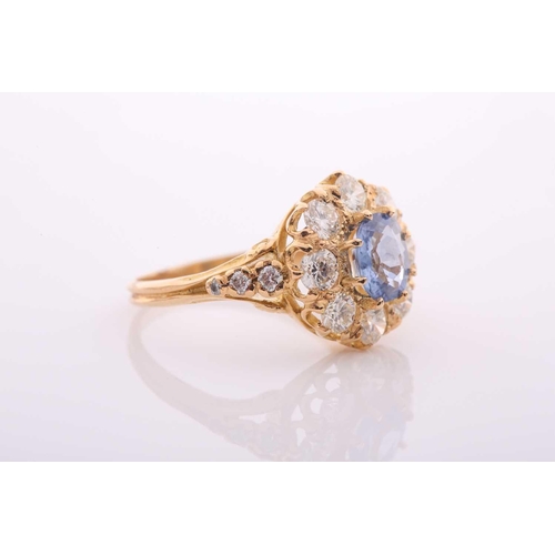 152 - A modern sapphire and diamond oval cluster ring in Victorian style, centred with an oval native-cut ... 