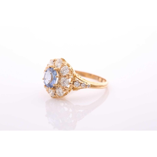 152 - A modern sapphire and diamond oval cluster ring in Victorian style, centred with an oval native-cut ... 