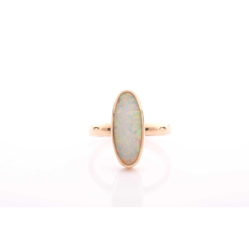 154 - A single stone opal ring, the elongated oval opal in rub over mount to a plain shank marked '750', 3... 