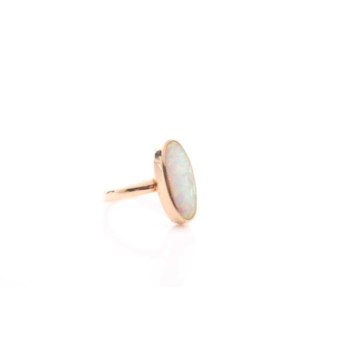 154 - A single stone opal ring, the elongated oval opal in rub over mount to a plain shank marked '750', 3... 