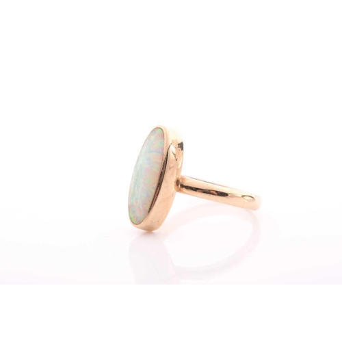 154 - A single stone opal ring, the elongated oval opal in rub over mount to a plain shank marked '750', 3... 