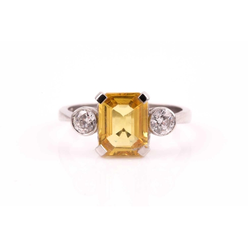 156 - A platinum, diamond, and yellow sapphire ring, set with a mixed rectangular-cut sapphire of approxim... 