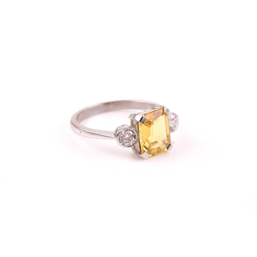 156 - A platinum, diamond, and yellow sapphire ring, set with a mixed rectangular-cut sapphire of approxim... 