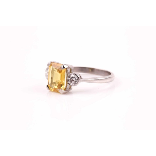 156 - A platinum, diamond, and yellow sapphire ring, set with a mixed rectangular-cut sapphire of approxim... 