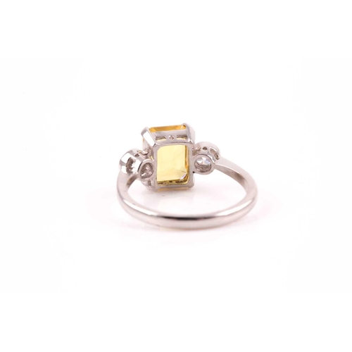 156 - A platinum, diamond, and yellow sapphire ring, set with a mixed rectangular-cut sapphire of approxim... 