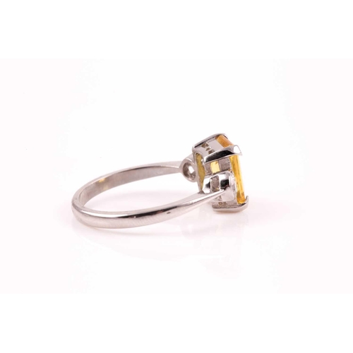 156 - A platinum, diamond, and yellow sapphire ring, set with a mixed rectangular-cut sapphire of approxim... 