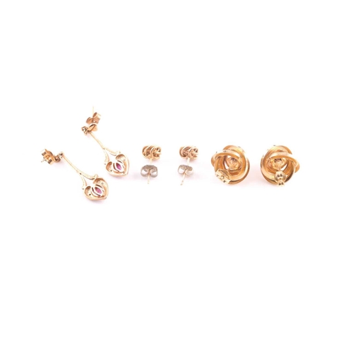 168 - A pair of ruby and diamond pendant earrings in 9 carat gold mounts; a pair of knot earrings and a pa... 