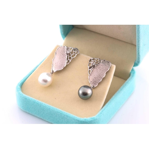 236 - A pair of silver, diamond, and South Sea pearl earrings, each with naturalistic handmade mount, with... 