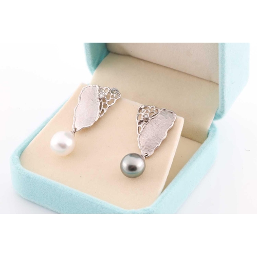 236 - A pair of silver, diamond, and South Sea pearl earrings, each with naturalistic handmade mount, with... 