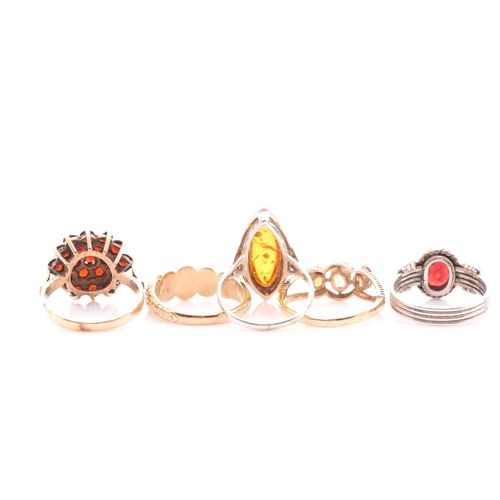 239 - A garnet cluster ring in 9 carat gold mount; a five stone half hoop cabochon garnet ring in 9 carat ... 