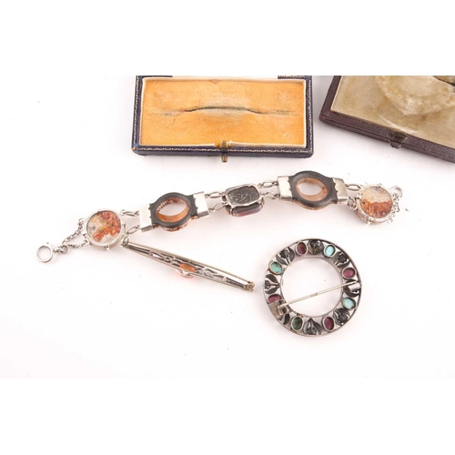 68 - A Scottish silver and hardstone bracelet, set with carved curved segments with silver mounts, and mu... 
