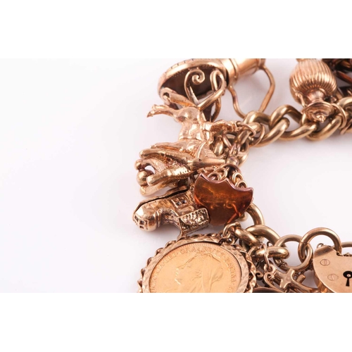 81 - A 9ct gold curb link ‘charm bracelet on a padlock clasp, London 1975, and hung with 16 various charm... 