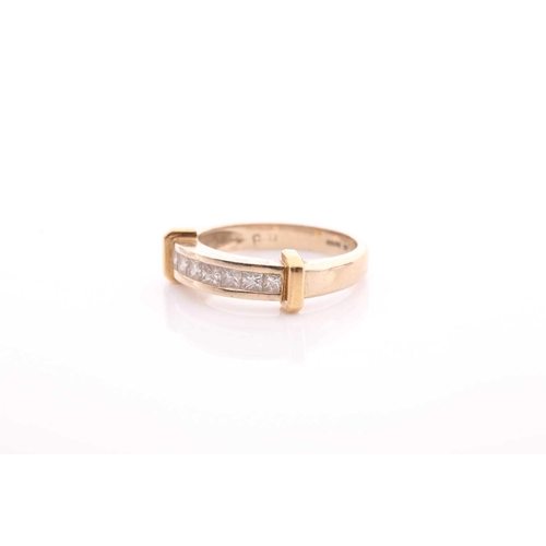 82 - A seven stone half hoop diamond ring; the princess cut diamonds channel set within a bi coloured 18 ... 