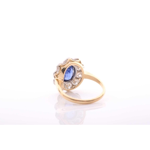 95 - A modern sapphire and diamond oval cluster ring, centred with an oval mixed-cut sapphire approximate... 