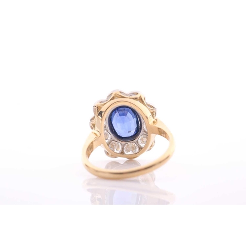 95 - A modern sapphire and diamond oval cluster ring, centred with an oval mixed-cut sapphire approximate... 