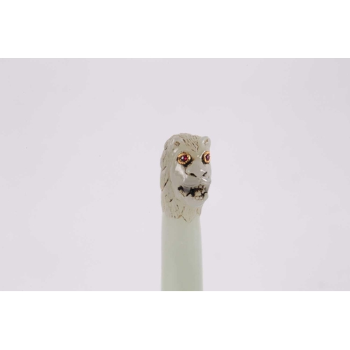 108 - An Indian pale sage coloured jade seal of cylindrical form with snarling lions head terminal with ye... 