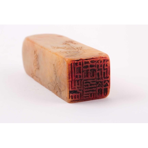 125 - A Chinese Shoushan stone seal, relief carved with figures crossing a bridge, mountains and buildings... 