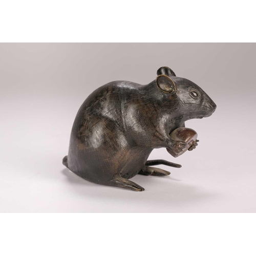 140 - A Japanese bronze rat, Meiji period, seated on its haunches, holding a chestnut, kakihan to base, 9.... 