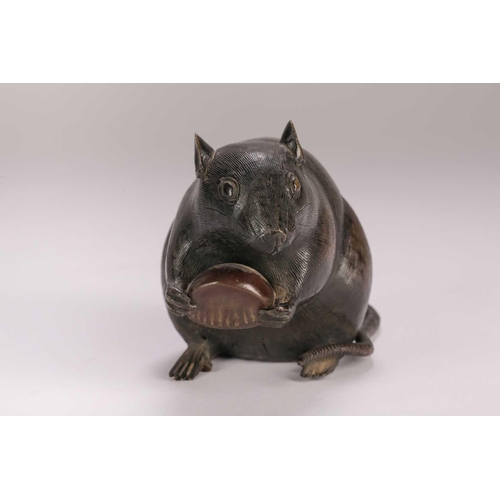 140 - A Japanese bronze rat, Meiji period, seated on its haunches, holding a chestnut, kakihan to base, 9.... 