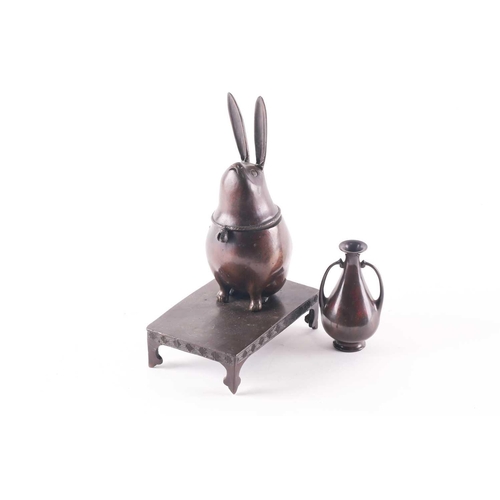 146 - A Japanese bronze incense burner, Meiji period, modelled as a moon gazing hare, a bell attached to i... 