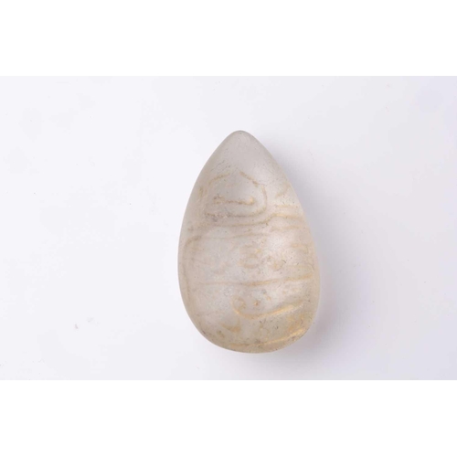 147 - An Indian carved rock crystal tear form panel with an engraved and gilt devotional inscription in Ar... 