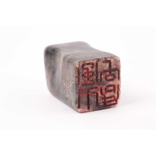 148 - A Chinese soapstone seal, Qing, of rectangular form, the stone shaped to fit a hand, the matrix with... 