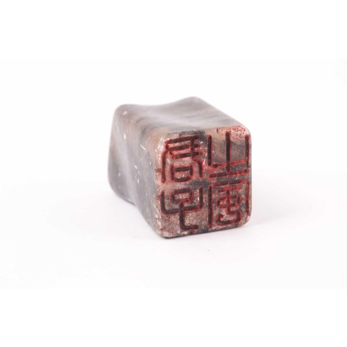 148 - A Chinese soapstone seal, Qing, of rectangular form, the stone shaped to fit a hand, the matrix with... 