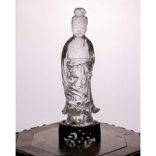 163 - A Chinese rock crystal figure of Guanyin, late Qing, standing in long flowing robes, her hair in a c... 