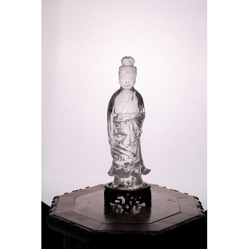 163 - A Chinese rock crystal figure of Guanyin, late Qing, standing in long flowing robes, her hair in a c... 