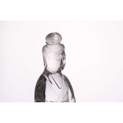 163 - A Chinese rock crystal figure of Guanyin, late Qing, standing in long flowing robes, her hair in a c... 