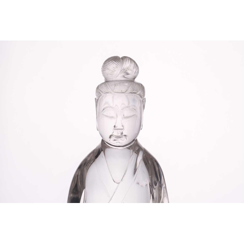 163 - A Chinese rock crystal figure of Guanyin, late Qing, standing in long flowing robes, her hair in a c... 