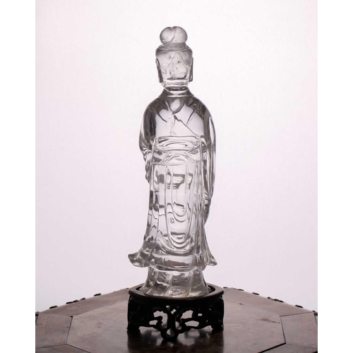 163 - A Chinese rock crystal figure of Guanyin, late Qing, standing in long flowing robes, her hair in a c... 