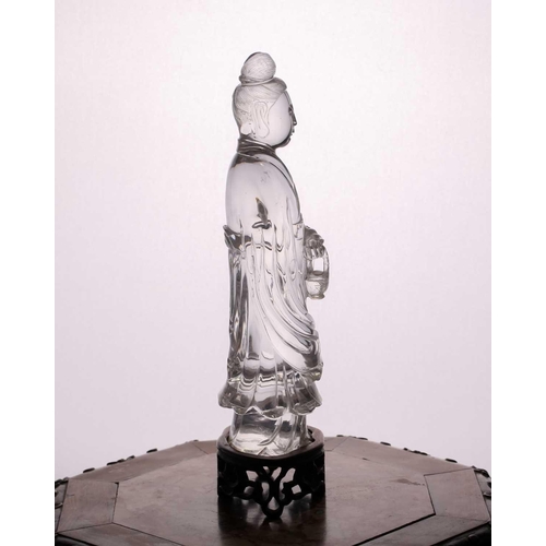 163 - A Chinese rock crystal figure of Guanyin, late Qing, standing in long flowing robes, her hair in a c... 