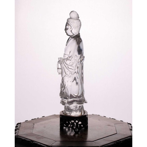 163 - A Chinese rock crystal figure of Guanyin, late Qing, standing in long flowing robes, her hair in a c... 