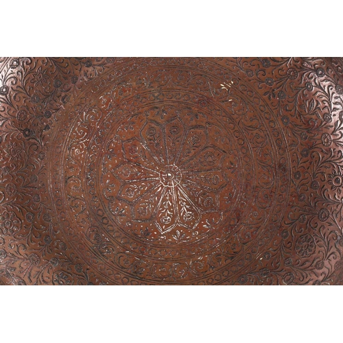 167 - A Mughal carved copper plate, 17th/18th century, Mughal, India, with floral design and calligraphic ... 