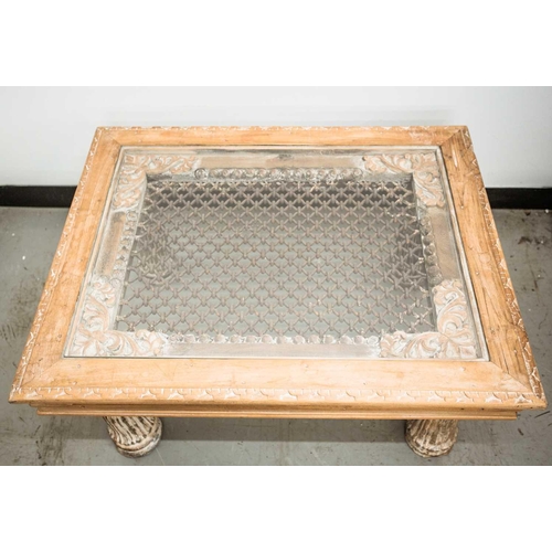 168 - An Indian hardwood coffee table, 20th century, constructed from a window with metal grill and set in... 