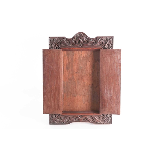 169 - An Indian carved padouk picture frame, late 19th century, with gothic brass hinges, and later oak ea... 