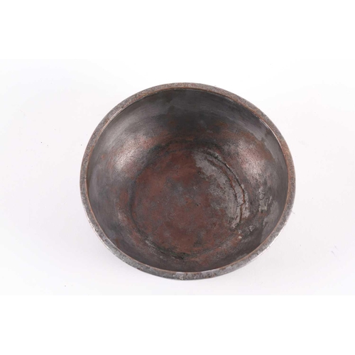 174 - A Safavid copper tinted bowl, 17th century, Iran, Persia, with a band of calligraphic inscription, 1... 