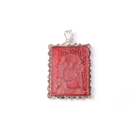 180 - A Persian white metal mounted rectangular red hardstone rectangular cartouch pendant, intaglio cut w... 