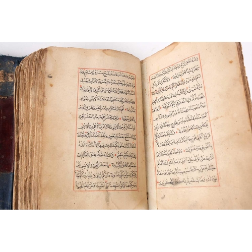 198 - A probably early 20th century Holy Quran with handwritten black and red Islamic script within gilt b... 