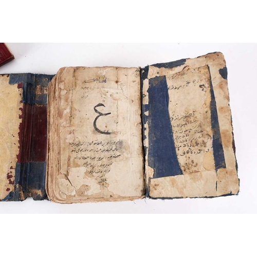 198 - A probably early 20th century Holy Quran with handwritten black and red Islamic script within gilt b... 