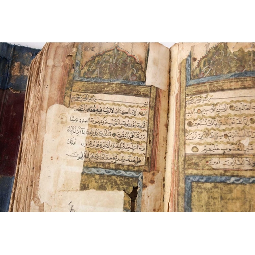 198 - A probably early 20th century Holy Quran with handwritten black and red Islamic script within gilt b... 