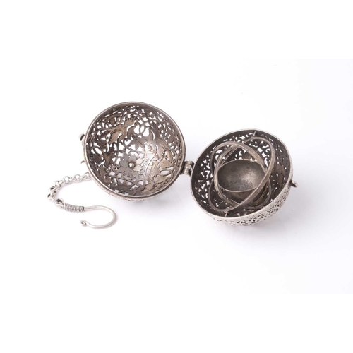 206 - A probably Indian white metal spherical hanging pomander. With an engraved and pierced exterior the ... 